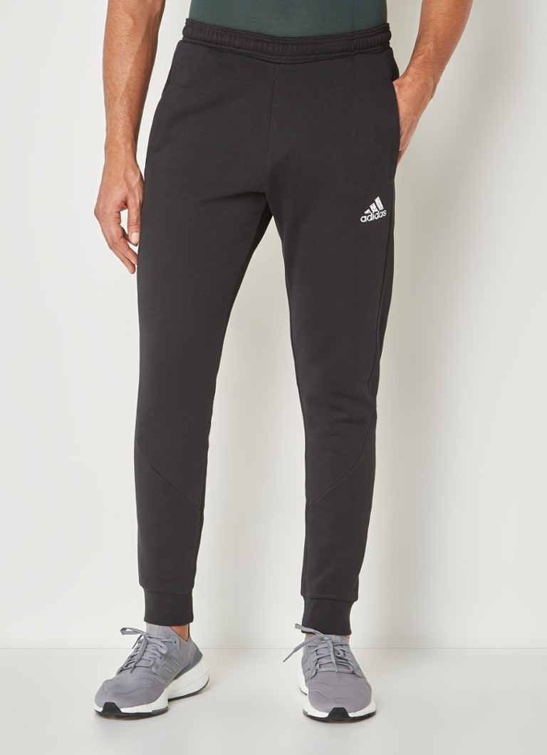 adidas - Tapered fit joggingbroek met logo en steekzakken - Zwart