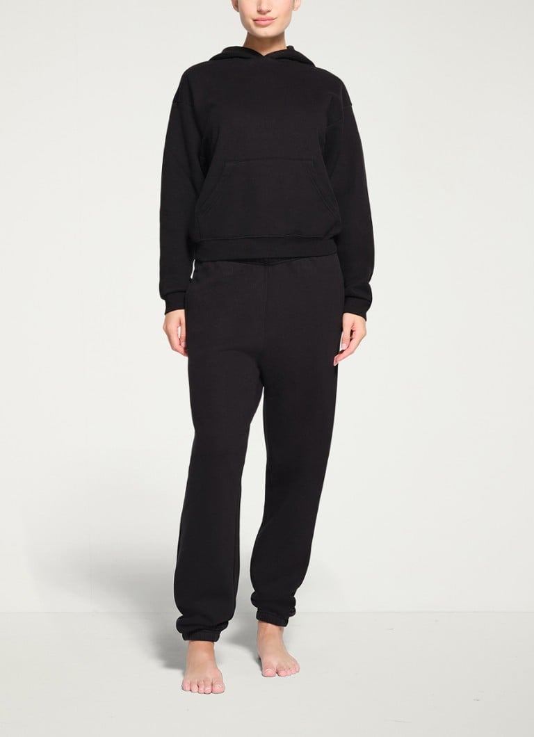 SKIMS - Cotton Fleece mid waist tapered fit loungebroek met steekzakken - Zwart
