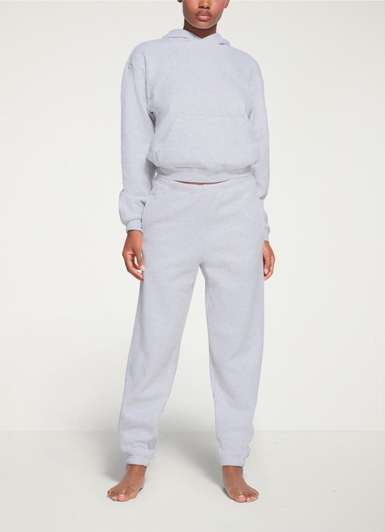 SKIMS - Cotton Fleece mid waist tapered fit loungebroek met steekzakken - Lichtgrijs
