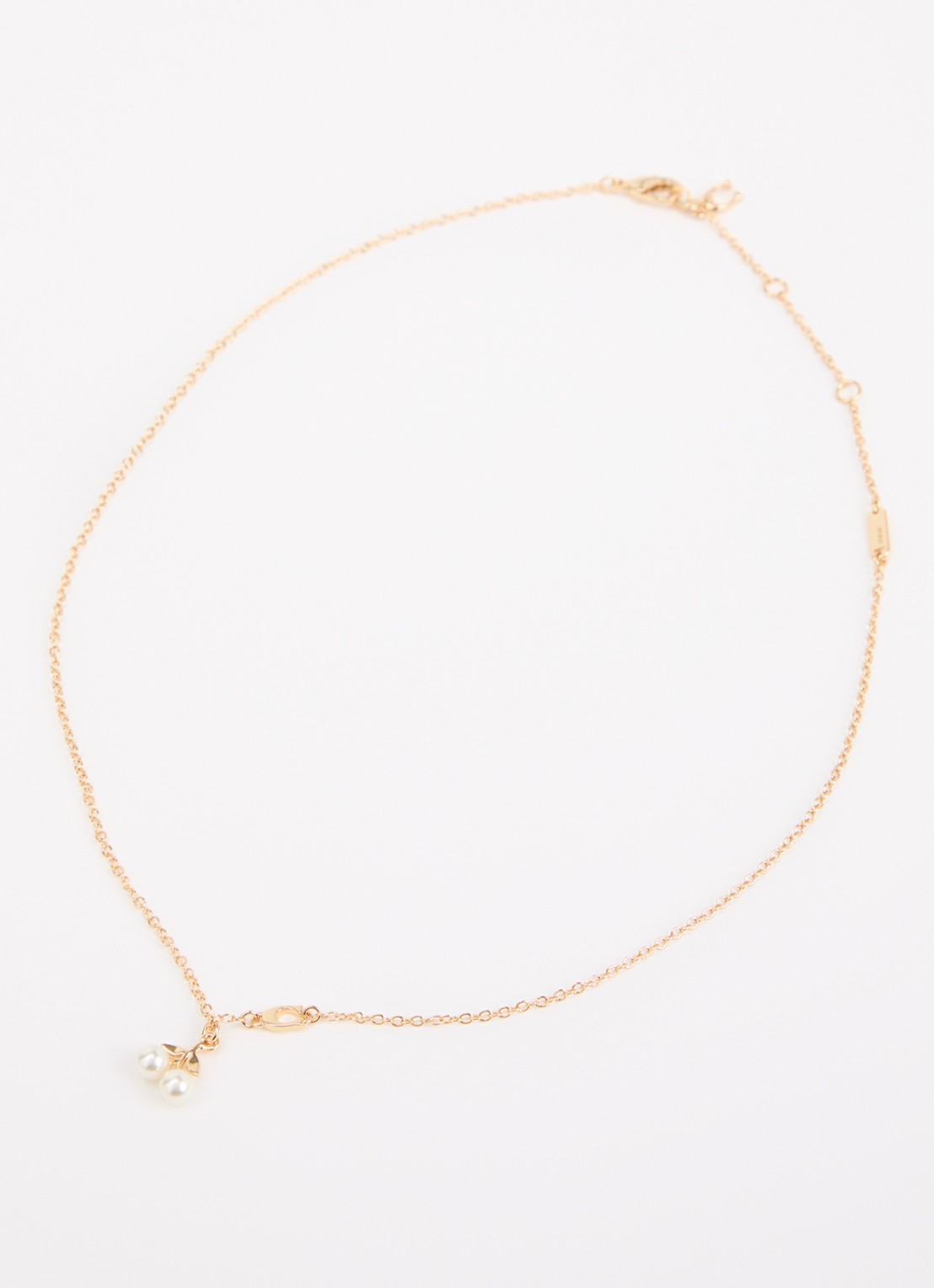 Coach Pearl Cherry ketting met hanger - detail goud