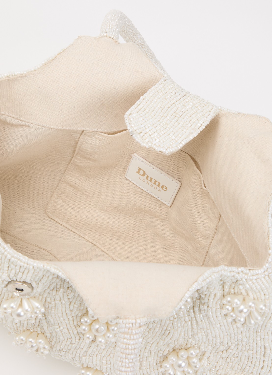 Dune London Dunmore schoudertas met kralendecoratie - detail ivoor