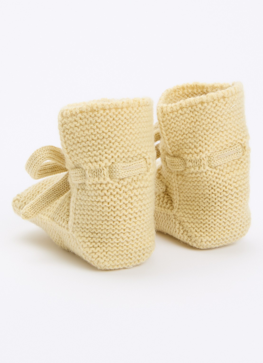 Hvid Babyslofjes van merino wol - achterkant vanillegeel