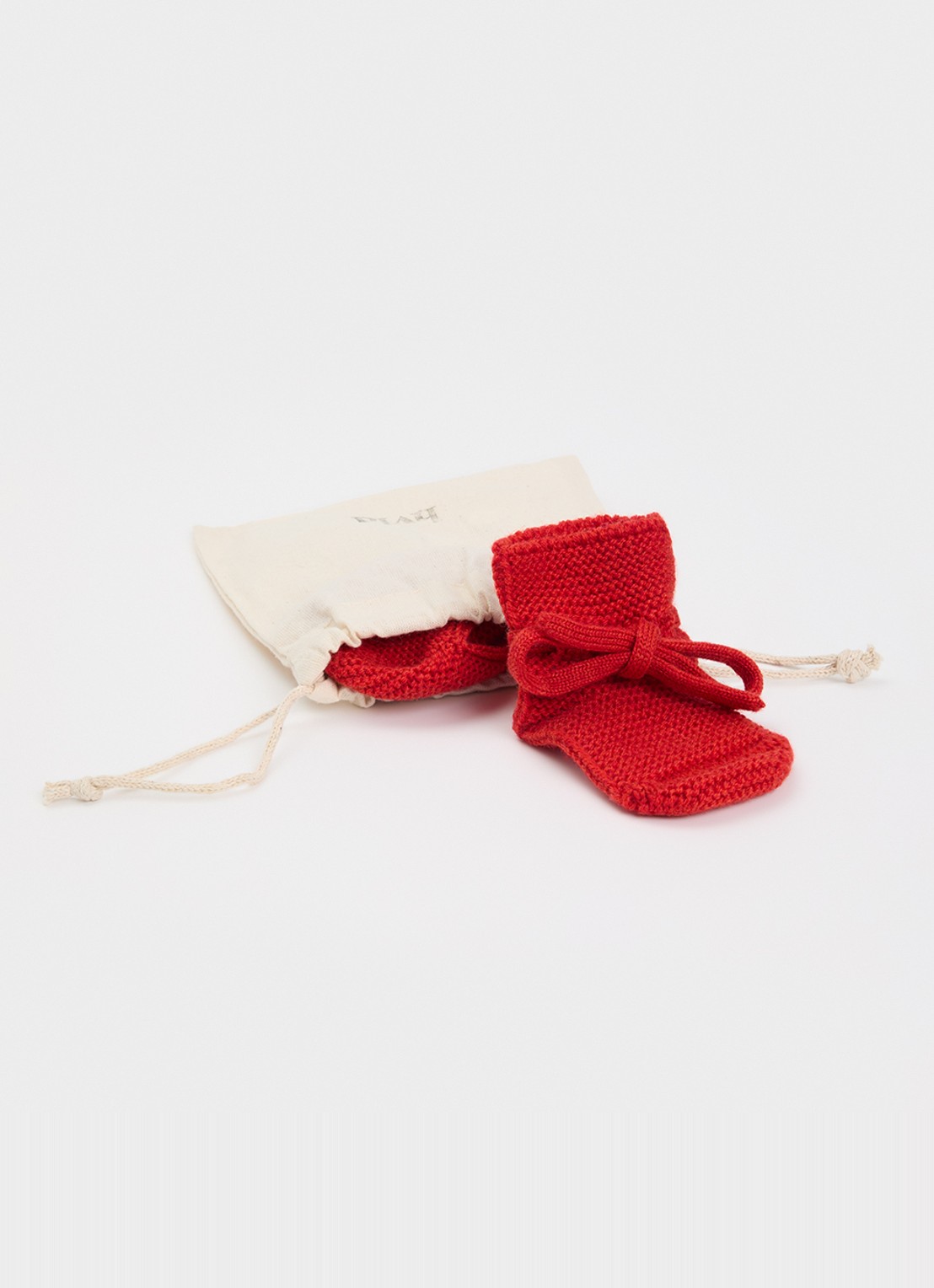 Hvid Babyslofjes van merino wol - voorkant 2 rood